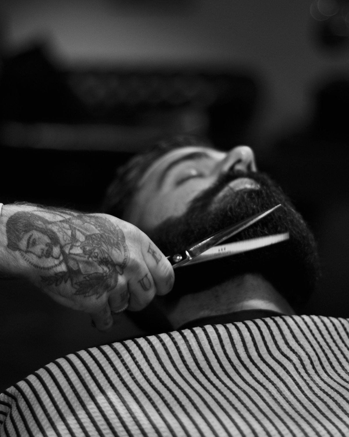 A barber finishing a fade at the first chair